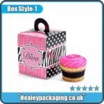 Pink Diva-themed cupcake box with handle and zebra print design, shown with a decorated cupcake