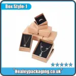 cardboard jewellery boxes with necklaces and rings inside