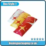Colorful pillow-style shawarma packaging sleeves with red, yellow, and white design