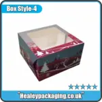 Square Christmas cake box with winter scene and clear window to display the cake inside.
