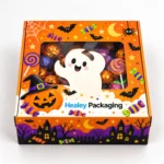 Halloween treat box with clear window displaying sweets and colourful ghost graphics.