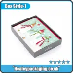 Grey Christmas card gift box with illustrated snowman cards inside.
