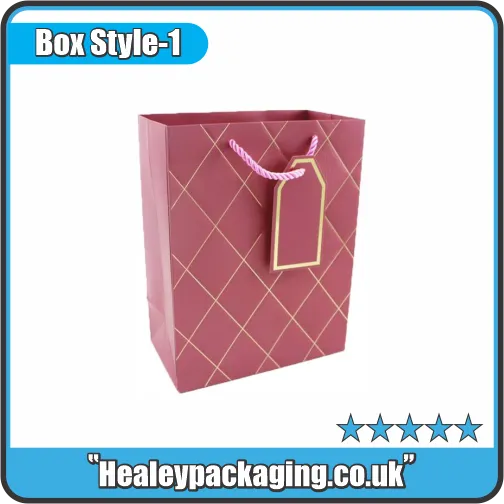 Elegant maroon gift bag with gold diamond pattern, pink rope handles, and matching gold-edged tag.