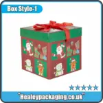 Christmas gift box with lid and ribbon, featuring festive printed designs for seasonal gift packaging.