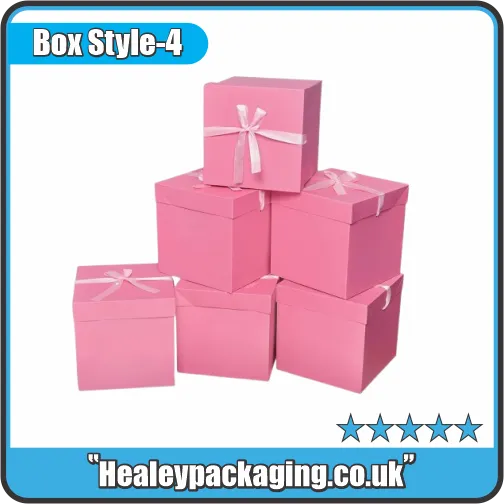 Stacked pink gift boxes with lids and ribbon ties, suitable for luxury gifting and retail presentation.