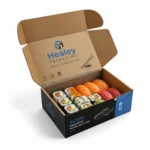 Open printed sushi mailer box with assorted sushi and kraft interior