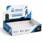 Open cardboard action figure display tray with a printed header and blue branding.