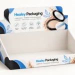 Open cardboard compact powder display box with branded header and white interior.
