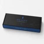 Black and blue printed pen packaging box with branded lid and decorative pen nib artwork.